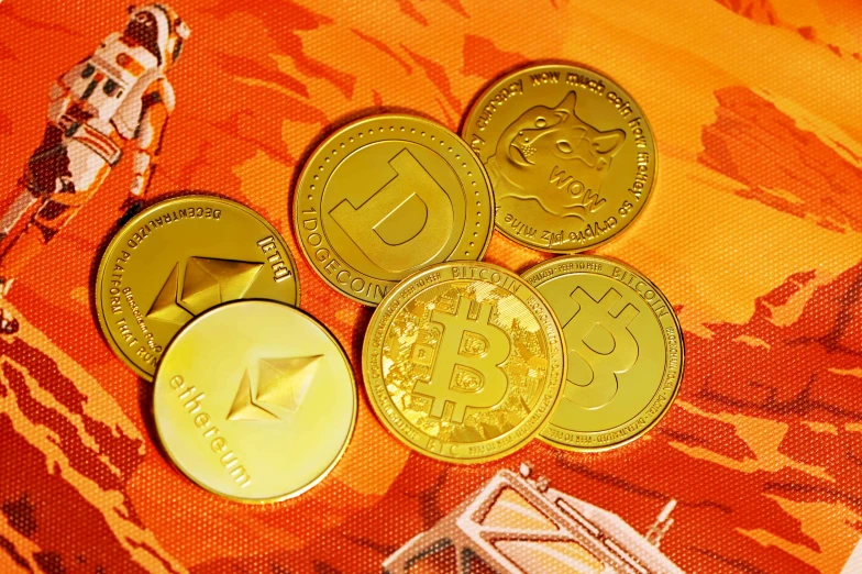 three golden metal coins laying on top of a table