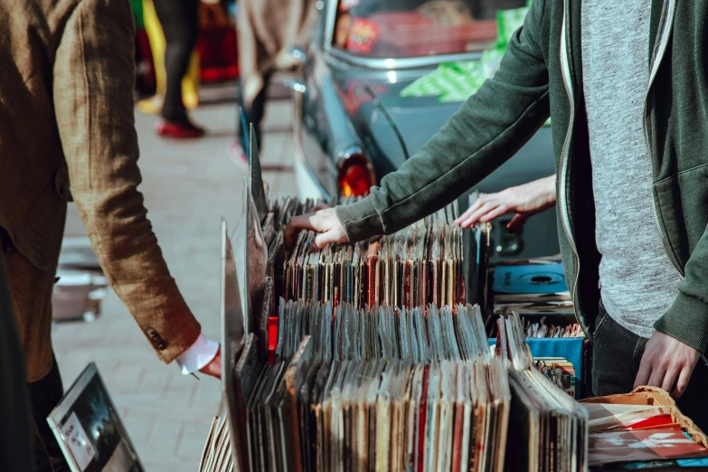 two people are shopping for vinyl record cds