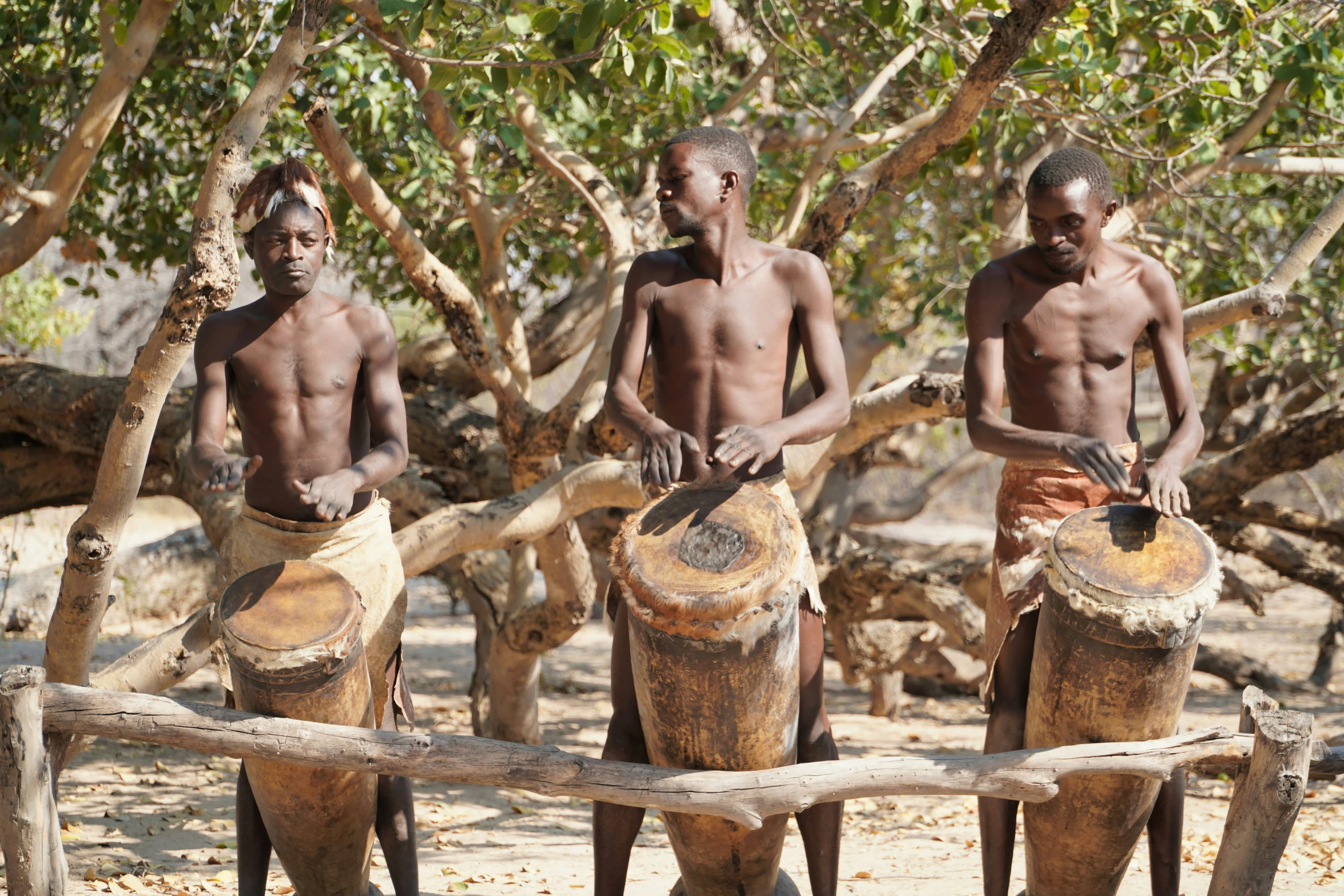 the men are standing around with wooden pots