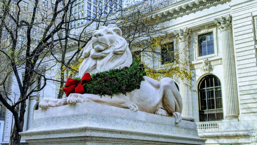 a stone lion sculpture is displayed in front of a building