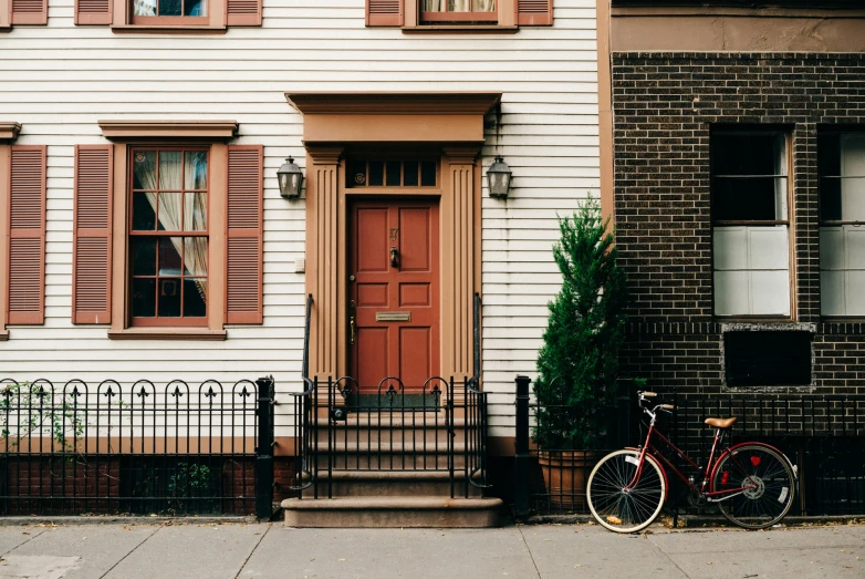 there is a bike leaning on the pole next to a house