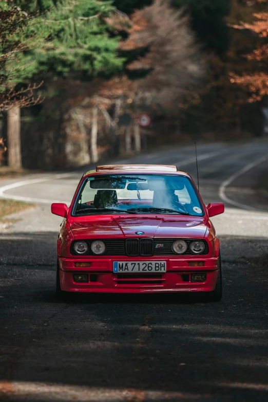 a red car that is on the side of the road