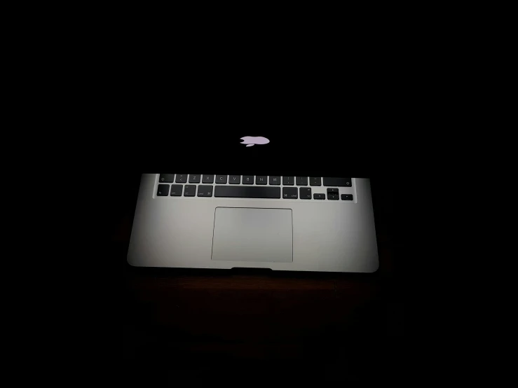 an apple macbook pro with a black background