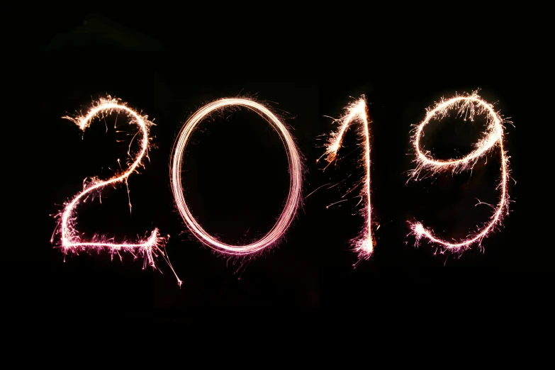 the word new year written with sparklers