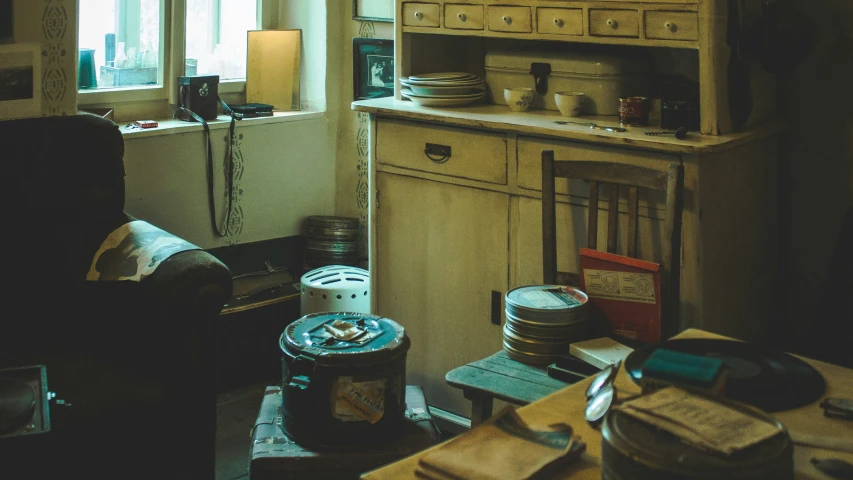 an old, dusty living room with dishes stacked on top of a dresser