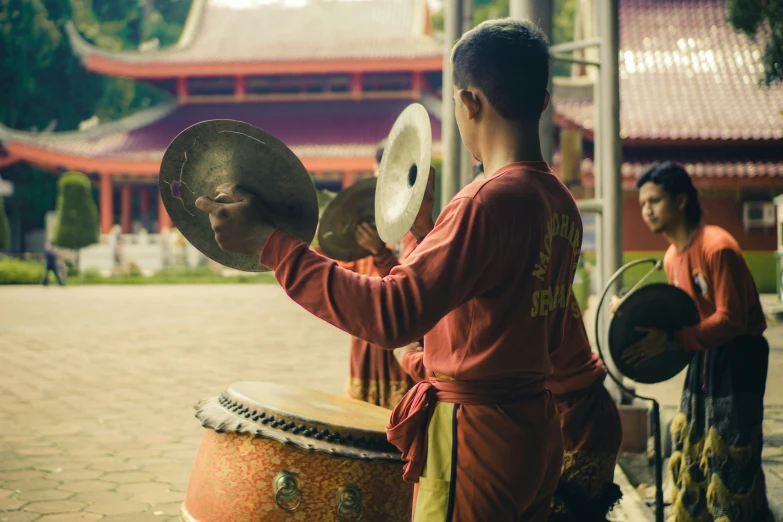 a woman with a hand drum stands near other women