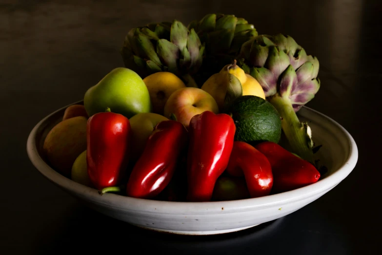 many pieces of fruits and vegetables in a bowl