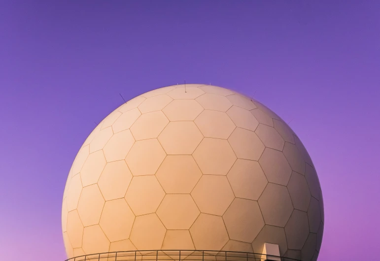 a large building in front of a purple sky