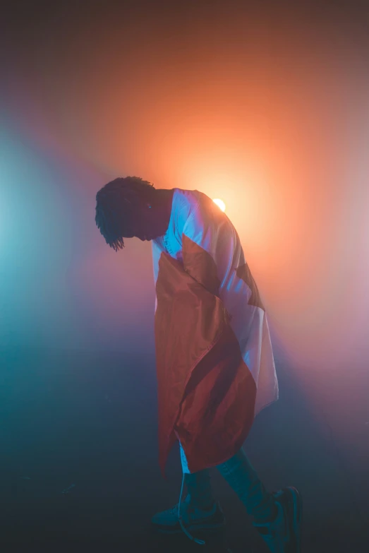 a person is standing on a stage with a flag