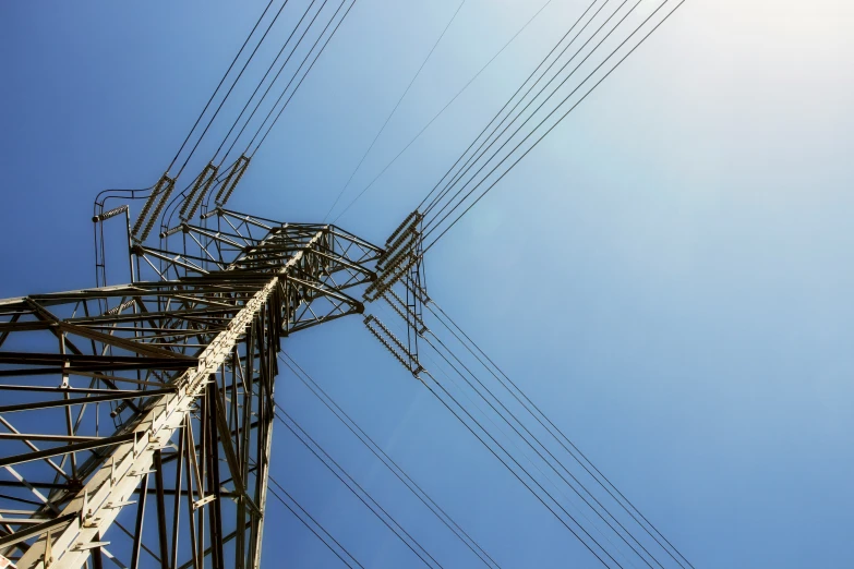 the top of a tall metal tower with lots of wires