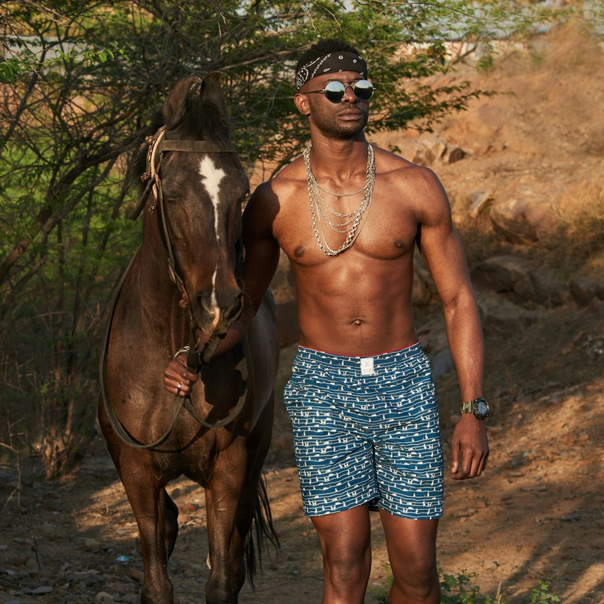 a man poses for a picture next to a horse