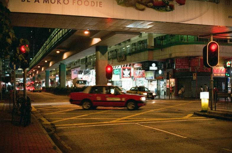 a red car waiting to enter a market