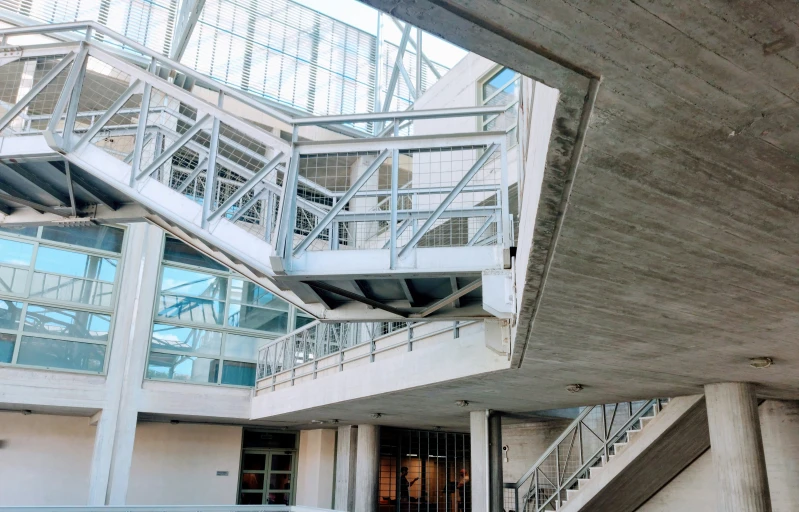 an office building with several glass windows and stairs