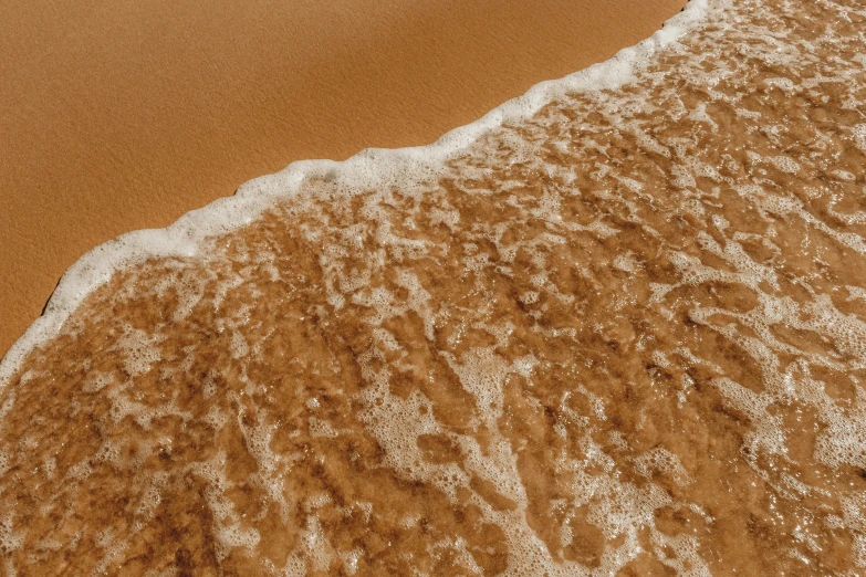 an image of a wave coming up the beach