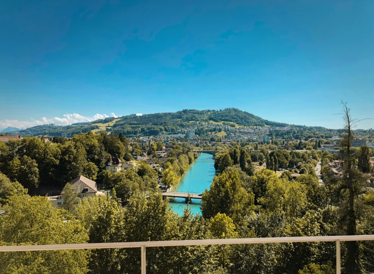 a hill is shown near a river in the distance