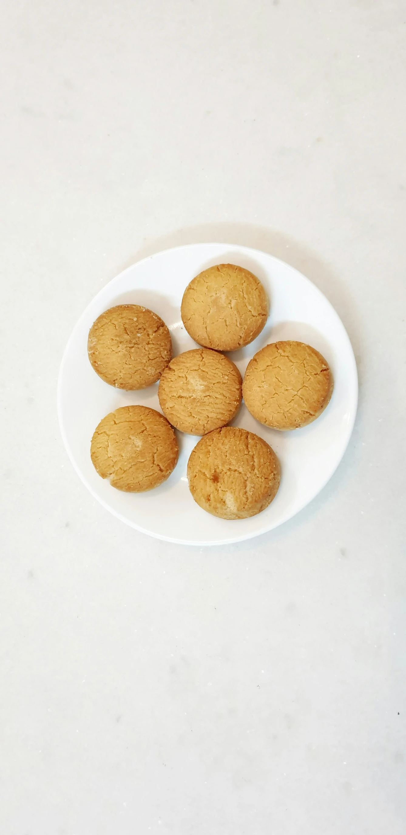 four cookies arranged on a white plate