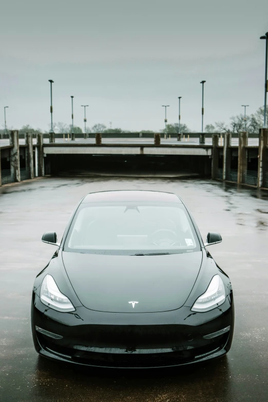 a dark colored car parked on a parking lot