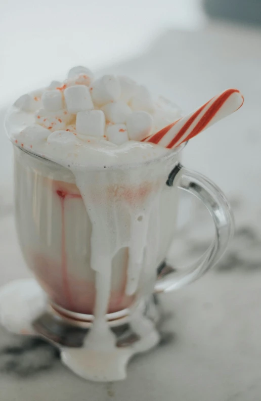 there is a cup filled with marshmallows and ice