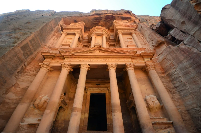 the facade of a building with multiple stone columns