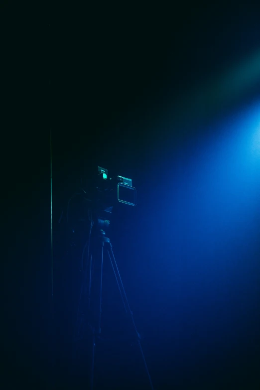 light on the ground and a pographer on the stage