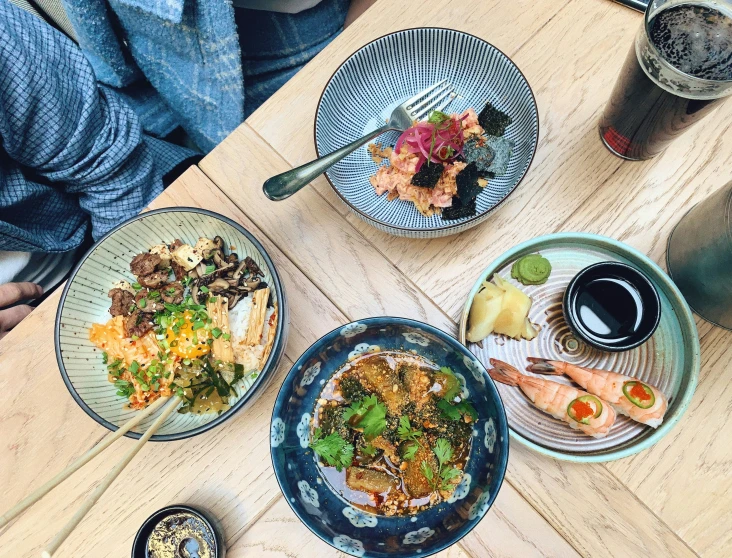 various dishes of food on plates sitting on a table