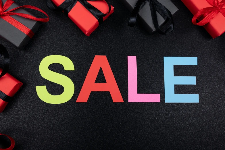 a colorful sale tag on black with gifts surrounding