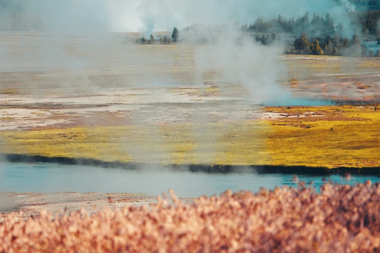 this po shows colorful water and grass with steam coming from them