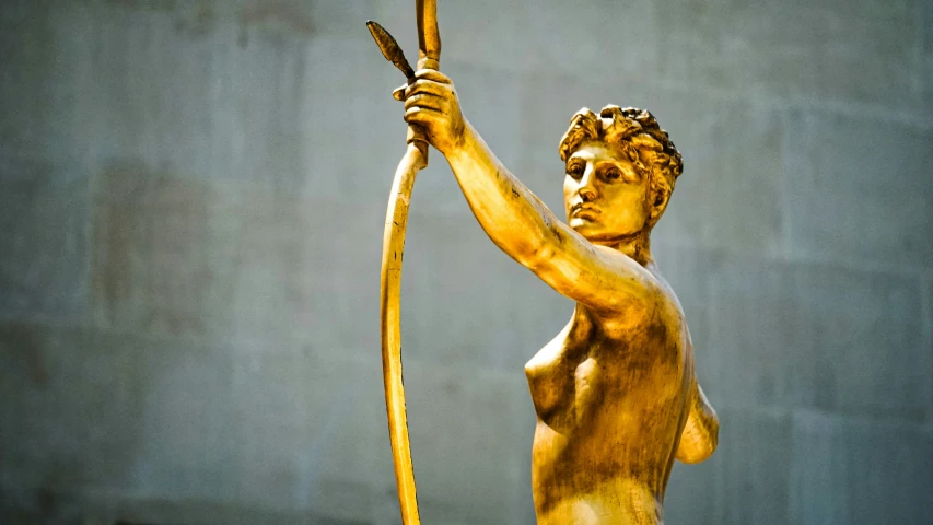 a statue in the shape of a man with a bow and arrow