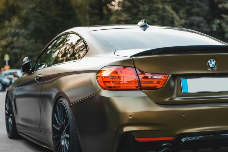 a picture of a gold color bmw coupe