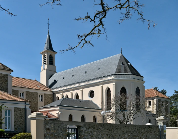 an old building with a clock and a stone fence