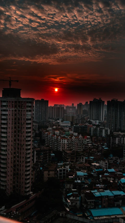 the sun is setting in the background of a city