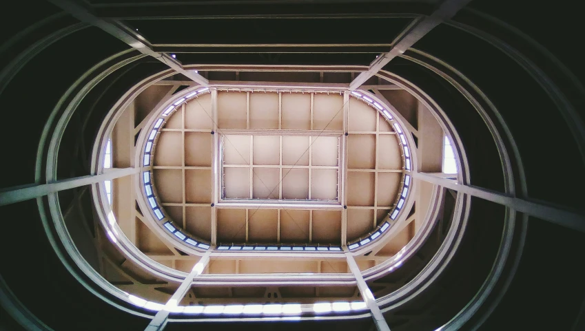 looking up at the ceiling of an iron and glass structure