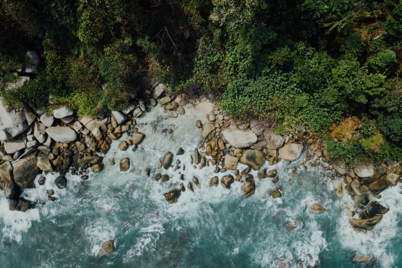 top down view of an aerial view of the ocean and rocks