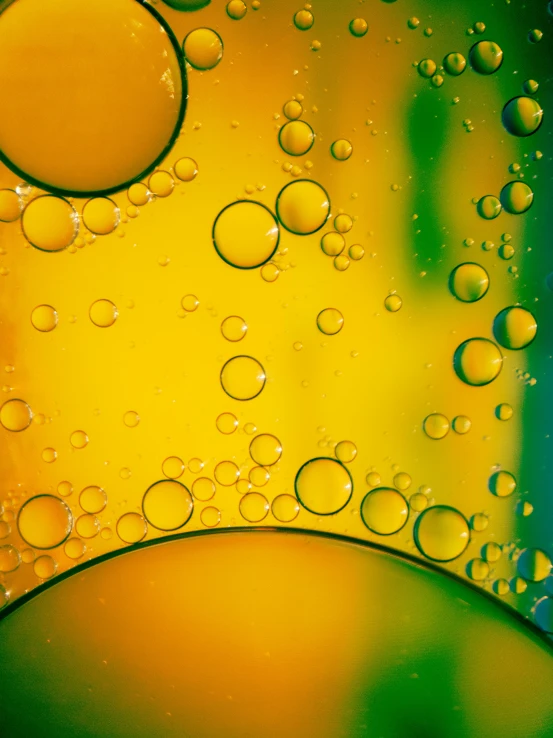 a yellow and green background with bubbles