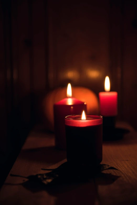 three candles lit on top of the table