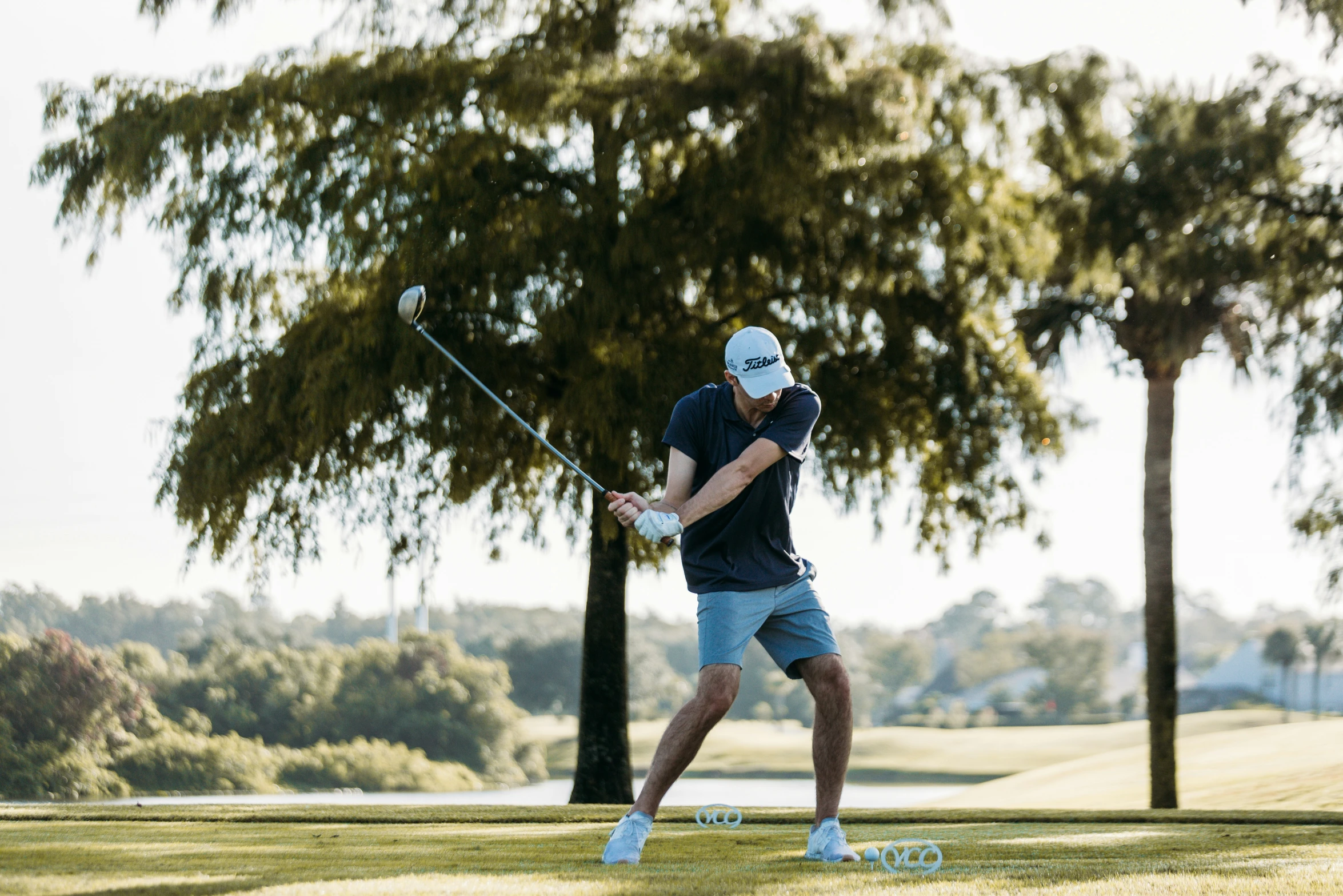 a man swinging his golf club on the course