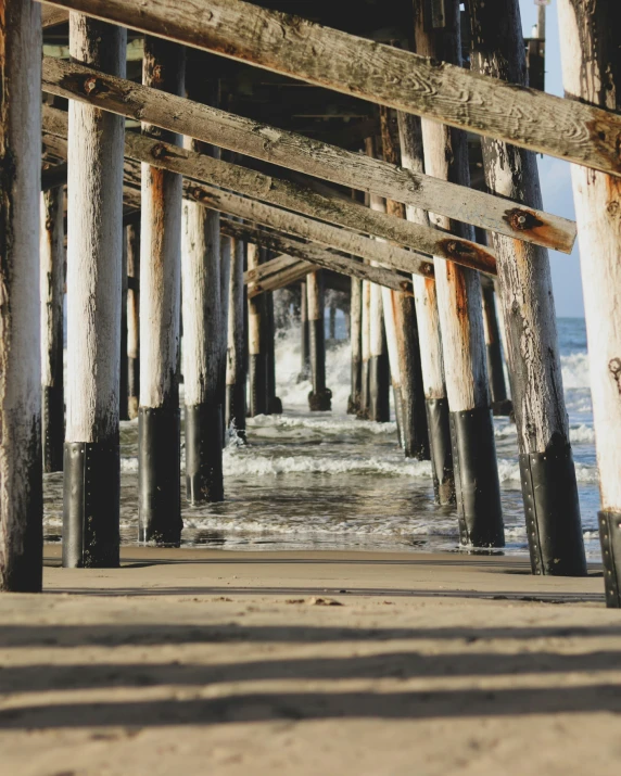 the underneath a wooden bridge and beach