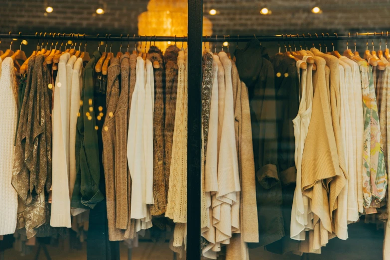 there are different clothes and robes hanging on racks