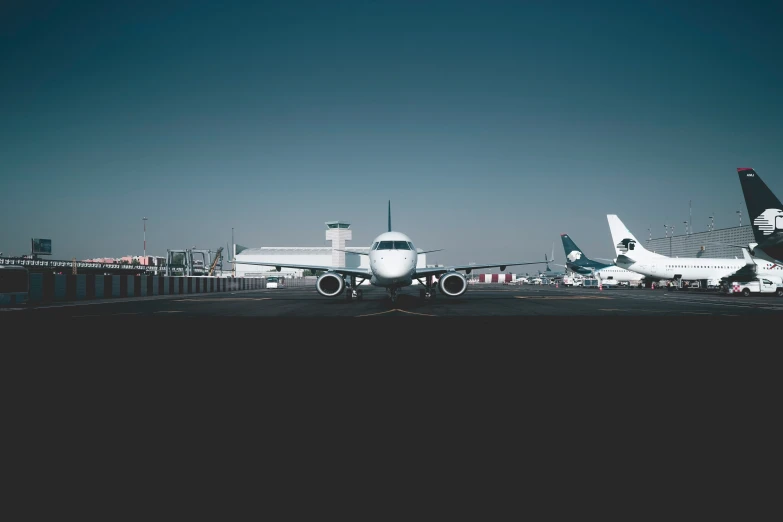 two planes parked on the tarmac at an airport