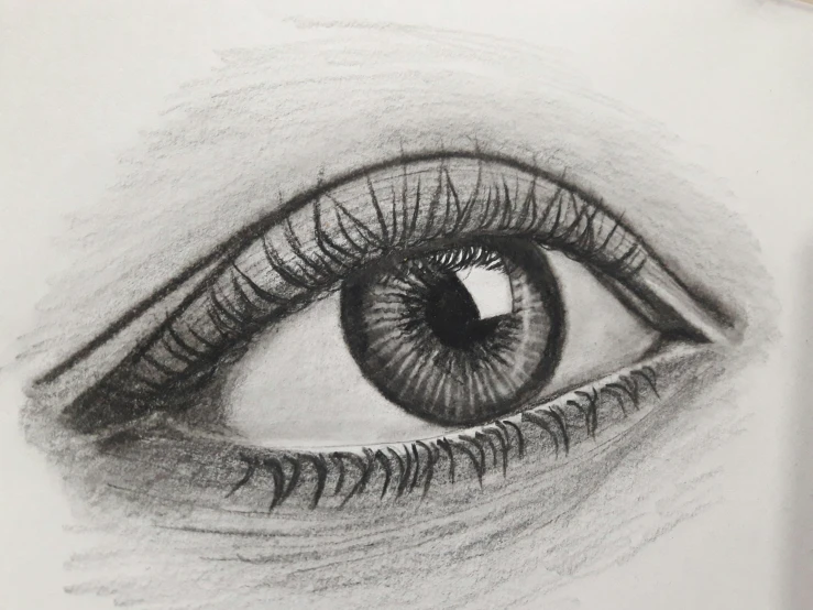 a drawing of an eye on top of a white surface