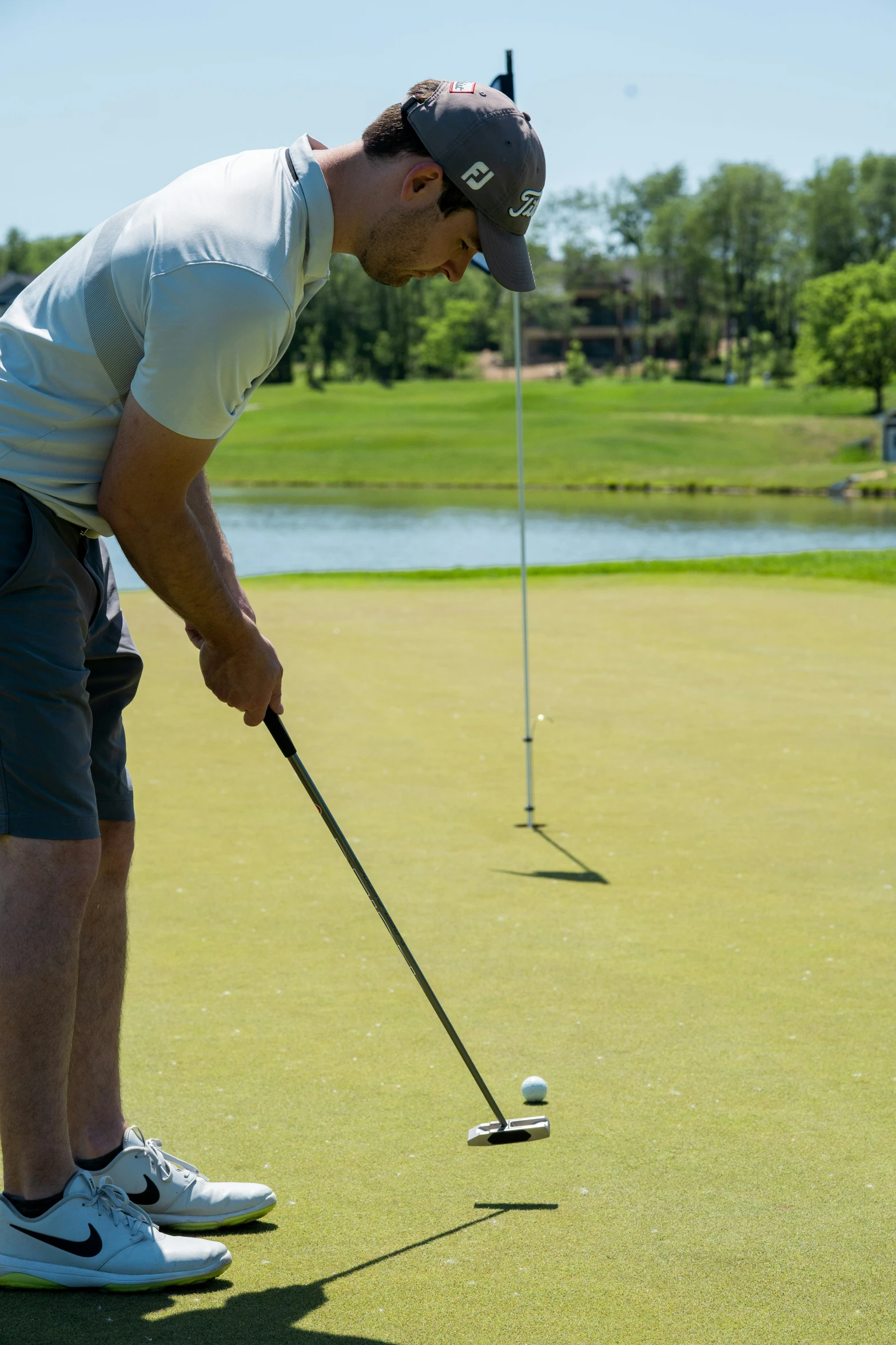 the man is playing a game of golf at a course