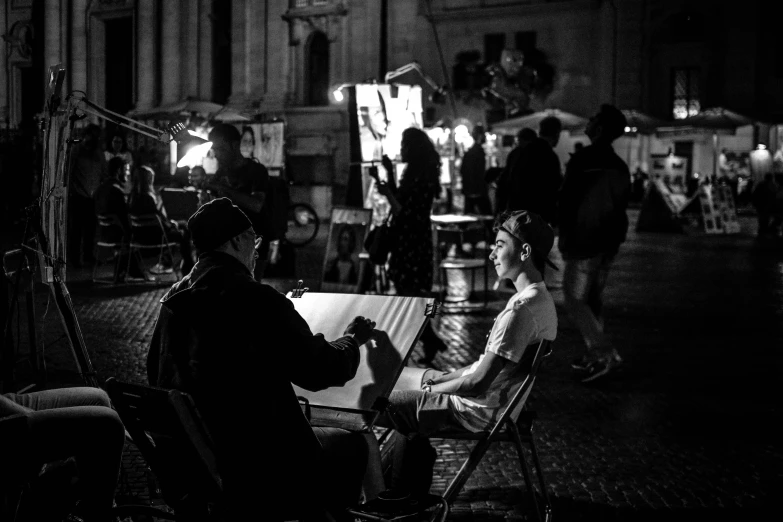 black and white image of two people sitting down