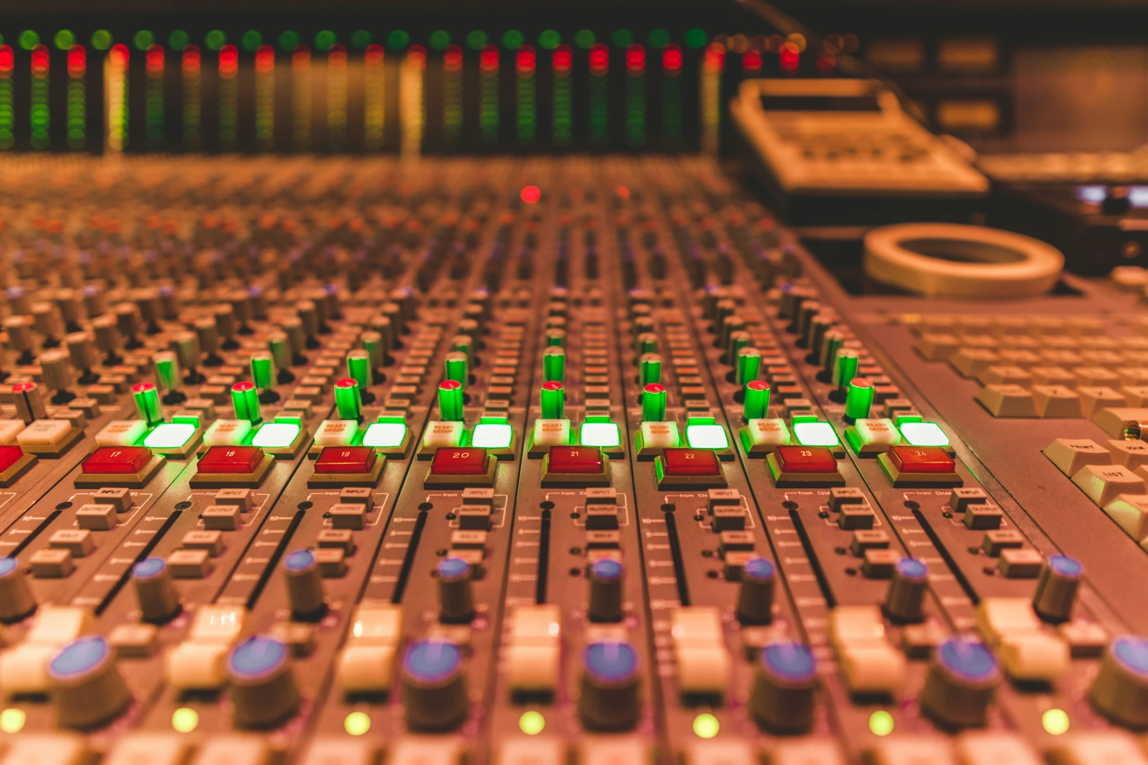 a mixer control room with green ons and other s