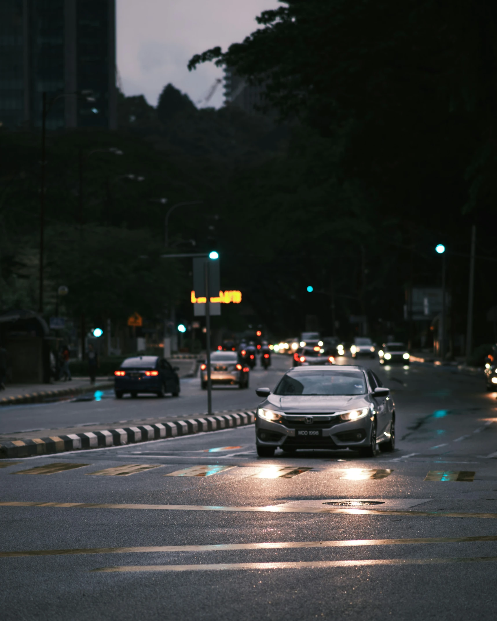 cars drive on the road with rain all around