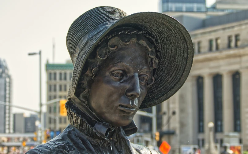 the statue shows a very attractive looking man in a straw hat