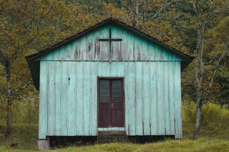 an old church stands in a grassy field