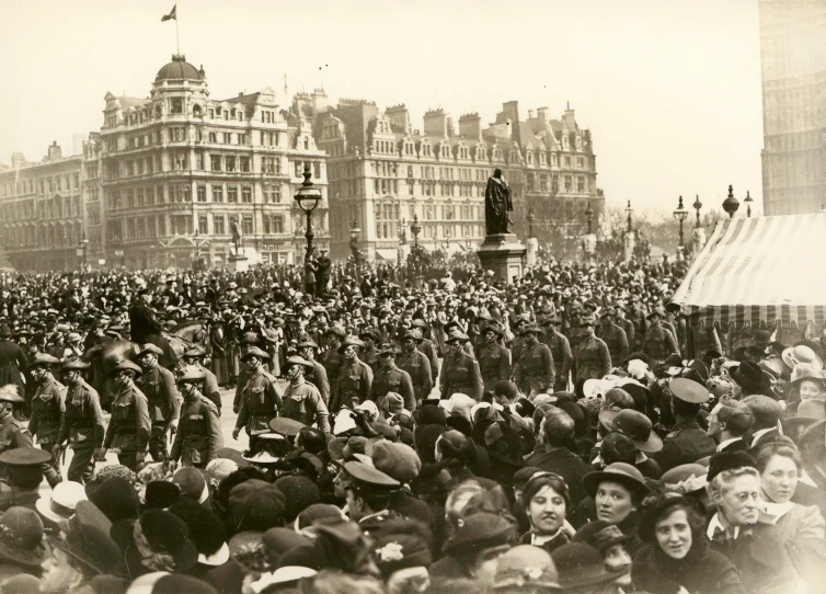 large crowd with dressed men gathered in a large city