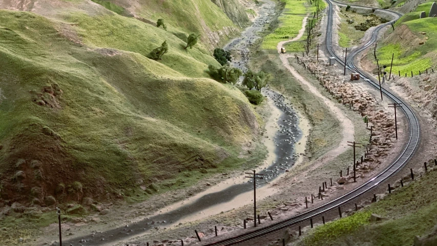 a train track running through an area that is hilly