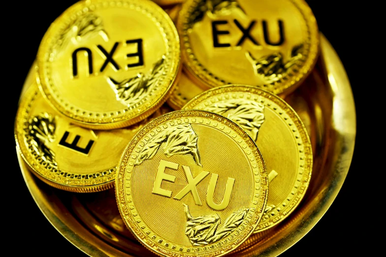 three gold colored foreign coins are on a black background