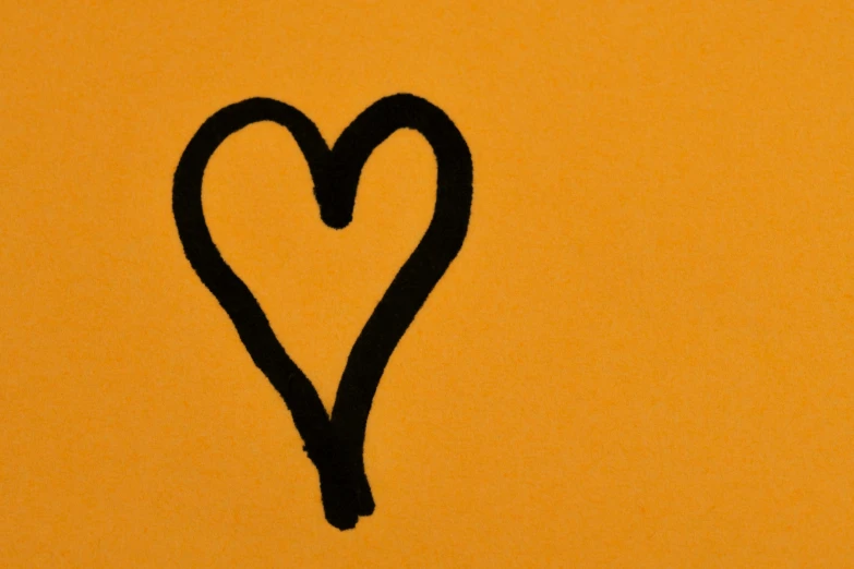 a heart drawn in black on an orange background